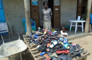 Betty in Uganda received a loan of $200 to increase her shoe inventory in her business in a trading center.