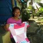 Regina from the Philippines received $125 to buy more clothing to expand her business selling clothing.