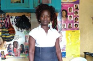 Grace from Kenya received a loan of $815 to add a small shop to sell cosmetic products.
