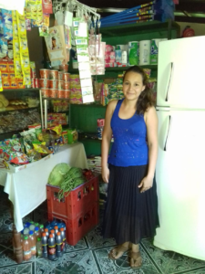 Glenda in El Salvador received a loan of $975 to buy milk, coffee, bread, vegetables, sodas, detergents, and other goods for her store.