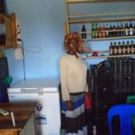 Justine in Uganda received a loan of $175 to buy supplies and increase revenue in her bar in a trading center.